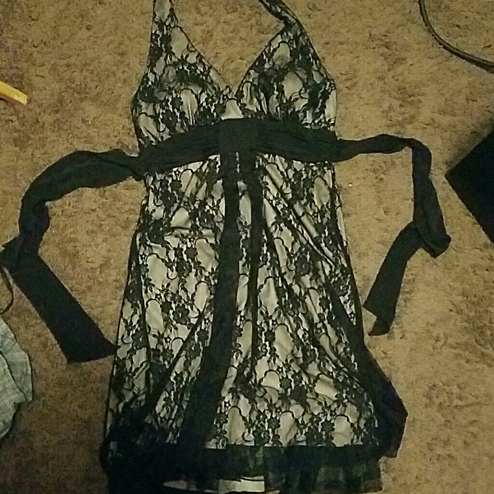 Black and cream colored almost knee length dress